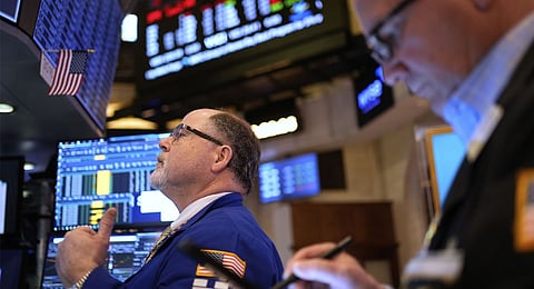 Traders work on the floor at the New York Stock Exchange in New York, Wednesday, April 9, 2025. 