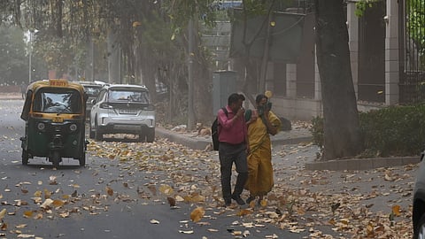 People cover their face to protect from dust during dust storm in New Delhi on Thursday