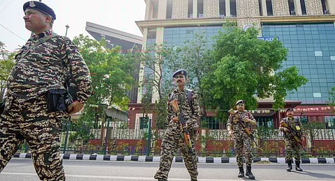 Security personnel guard outside the National Investigation Agency headquarters, in New Delhi, Thursday, April 10, 2025.