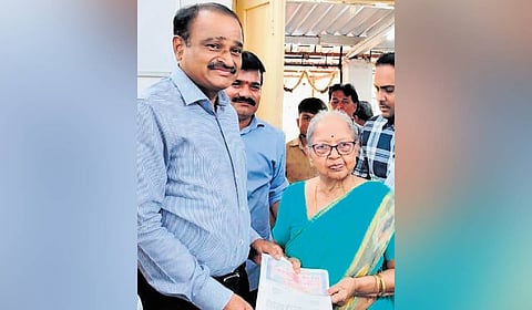 Stamps & Registration DIG N Saidi Reddy hands over documents to a citizen in Chikkadpally on Thursday