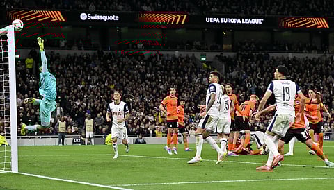 Eintracht Frankfurt's Brazilian goalkeeper #40 Kaua Santos dives to cover a side shot during the UEFA Europa League quarter-final football match between Tottenham Hotspur and Eintracht Frankfurt on April 10, 2025.