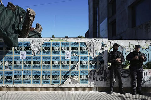 Signs that read in Spanish "Justice to God," cover a wall where police stand guard outside the court. It is here the medical team that treated the late soccer star Diego Maradona  is on trial facing charges of homicide by negligence in San Isidro, on the outskirts of Buenos Aires, Argentina, Thursday, April 3, 2025.