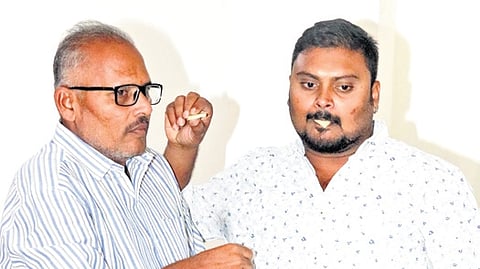 Kunamaneni Teja Sai and his father Srinivas Rao share sweets in Sangareddy  district on Saturday
