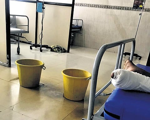 Water seeping from the ceiling collected in buckets at the Omandurar Government Multi-Super Speciality Hospital