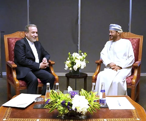 In this photo released by Iranian Foreign Ministry, Iranian Foreign Minister Abbas Araghchi, left, meets his Omani counterpart Sayyid Badr Albusaidi prior to negotiations with US Mideast envoy Steve Witkoff in Muscat, Oman, Saturday, April 12, 2025.