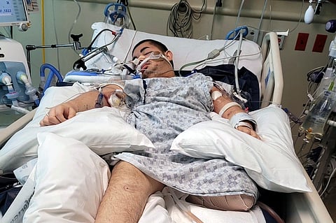 This photo provided by Ana L Vazquez, shows Victor Perez in a hospital bed in Pocatello, Idaho.