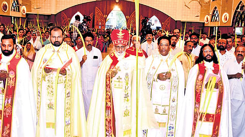 Mar Raphael Thattil, Major Archbishop of the Syro-Malabar Church, leads the Palm Sunday procession at Mary Queen Church, Thoppil, holding the blessed palms. The church stands out as one of the few in the Ernakulam-Angamaly Archdiocese that follows the Uniform Mass 