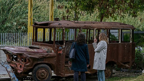 People view the bus that started the Lebanese civil war on April 13, 1975, when an ambush by Christian gunmen of a busload of Palestinians kicked off the war that lasted 15 years, displayed at Nabu Museum in Batroun, northern Lebanon, Saturday, April 12, 2025.