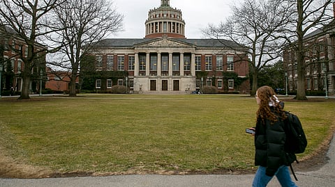 A student walks by the Rush Rhees Library at the University of Rochester, Feb. 22, 2023. 