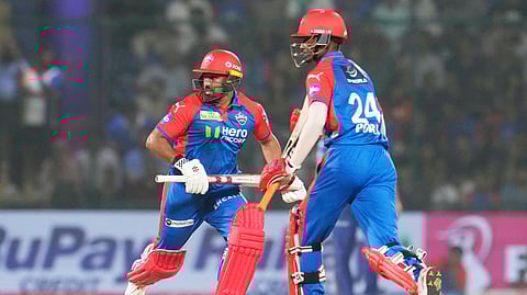 Delhi Capitals' Karun Nair, left, and Abishek Porel run between the wickets during the IPL match against Mumbai Indians at Arun Jaitley Stadium in New Delhi, India, Sunday, April 13, 2025.
