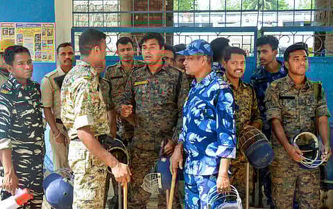 FILE | Security personnel stand guard at a school where violence-affected people from Murshidabad have taken shelter, in Malda district of West Bengal, Tuesday, April 25, 2025. 