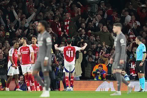 Arsenal's Declan Rice, right, celebrates with his teammates after scoring his side's opening goal during the Champions League quarterfinal first leg soccer match between Arsenal and Real Madrid at the Emirates Stadium in London, Tuesday, April 8, 2025.