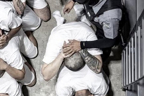 In this undated photo provided by the U.S. District Court for the District of Maryland in April 2025, a man identified by Jennifer Vasquez Sura as her husband, Kilmar Abrego Garcia, is forced to sit with other prisoners by guards in the Terrorism Confinement Center in Tecoluca, El Salvador.