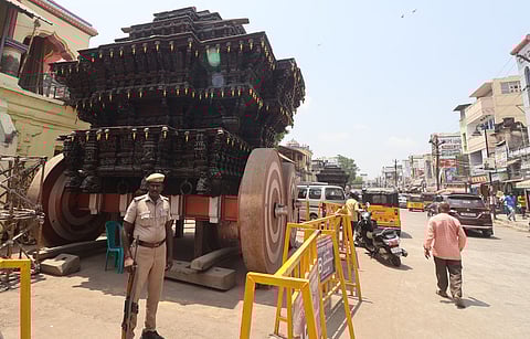 Ahead of the Chithirai Festival, police personnel is seen protecting the temple car of Meenakshi Amman Temple in Madurai.