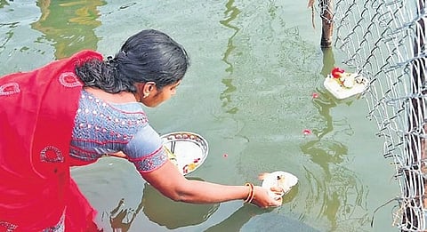 A woman places offerings.