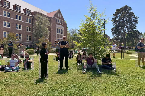 Florida State University students wait for news amid an active shooter incident at the school’s campus in Tallahassee, Fla., Thursday, April 17, 2025 