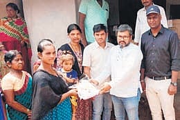 Andhra Pradesh deputy CM Pawan Kalyan distributing footwear to  tribal families.