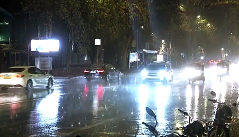  Vehicles ply on a road amid rainfall in New Delhi on Friday, April 18, 2025.