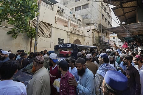 Police officers arrive to control the situation as supporters of TLP party hold a demonstration against the Pakistan's minority Ahmadi community outside their place of worship, in Karachi, Pakistan, Friday, April 18, 2025.
