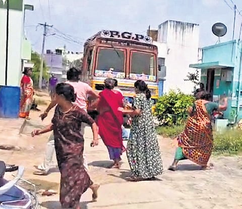 Women run for safety as Balamurugan tries to mow them down with a lorry