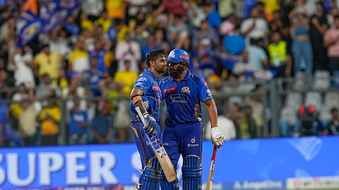 Mumbai Indians' Suryakumar Yadav , left, and his batting partner Rohit Sharma celebrates after winning the Indian Premier League cricket match against Chennai Super Kings at Wankhede Stadium in Mumbai, India, Sunday, April 20, 2025.