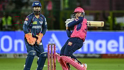 Rajasthan Royals' Vaibhav Suryavanshi (R) plays a shot as Lucknow Super Giants' wicketkeeper captain Rishabh Pant watches during the Indian Premier League (IPL) Twenty20 cricket match between Rajasthan Royals and Lucknow Super Giants at the Sawai Mansingh Stadium in Jaipur.