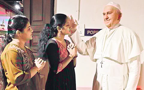 Faithful seek blessings before a wax statue of Pope Francis at Sunil’s Wax Museum, Thiruvananthapuram 