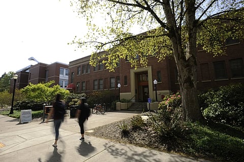 Oregon State University students walk past the Student Health Services building in Corvallis, Ore., in April 2016.