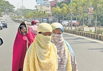 Covered with scarves, girls commute on a road in Jharsuguda on Tuesday
