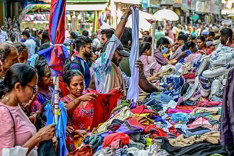 People shop at a market ahead of the upcoming traditional festival of Sinhala or Tamil New Year, in Colombo on April 8, 2025. 