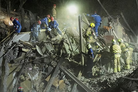 Rescuers and civilians worked to pull victims from the rubble of a residential building in Kyiv on Thursday