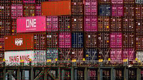 Shipping containers sit on the container ship One Manhattan at Port Jersey, Friday, April 18, 2025