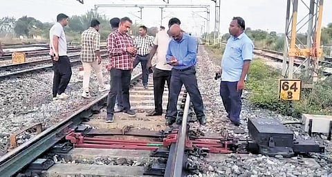 Officials inspect the railway tracks at Thiruvalangadu station, where the bolts from point machines were found to be deliberately removed