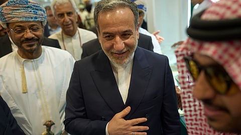 Iranian Foreign Minister Abbas Araghchi, center, and Omani Foreign Minister Badr al-Busaidi, left, walk through the Muscat International Book Fair in Oman, Friday, April 25, 2025. 