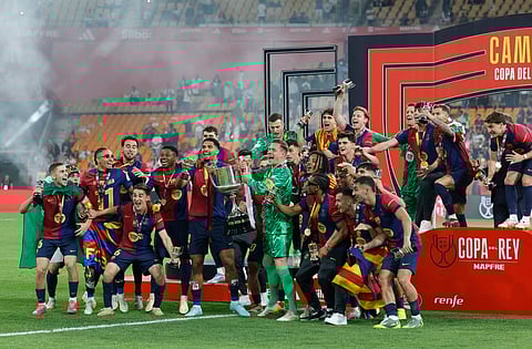 Barcelona players celebrate with the cup after winning the Spanish Cup, Copa del Rey (King's Cup) final football match between FC Barcelona and Real Madrid CF at La Cartuja stadium in Seville on April 26, 2025.