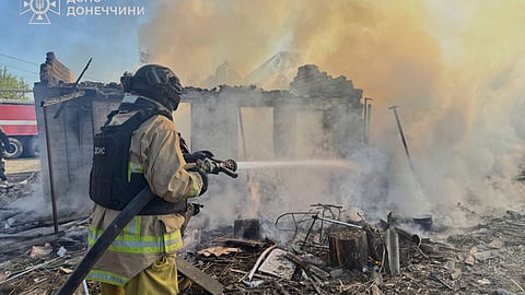 In this photo provided by the Ukrainian Emergency Service, a firefighter puts out a fire at ruined private houses following Russia's air raid in the Donetsk region, Ukraine, Monday, April 28, 2025. 