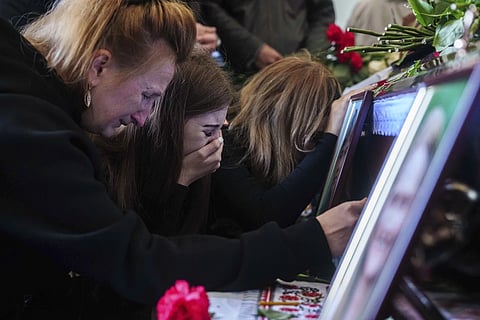Alyona Zavadska, 16, center, cries over the coffin of her boyfriend Danylo Khudia, 17, killed in a Russian strike along with his parents on April 24, during a farewell ceremony at the crematorium in Kyiv, Ukraine, on Monday, April 28, 2025.