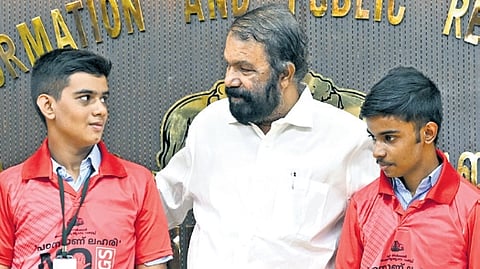 Minister V Sivankutty with children wearing the T-shirts designed for the mega zumba programme