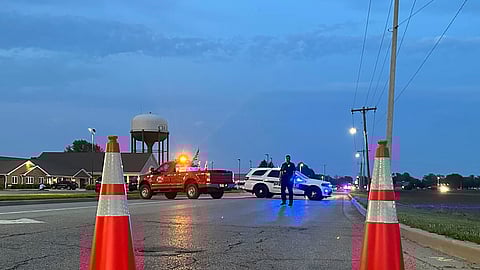 Police block a road leading to a building where a car smashed through during an after-school program, killing several people and injuring others, Monday, April 28, 2025, in Chatham, Ill.
