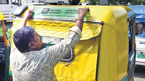 An autorickshaw driver in Kochi gets ready to operate under the digital  platform ‘kerala savaari’.