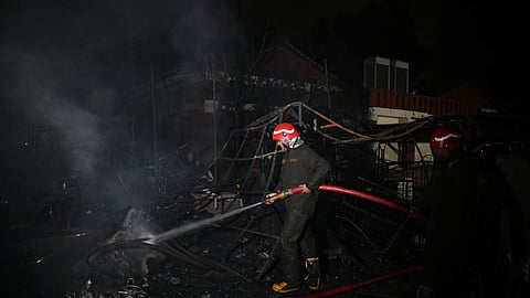 Fire fighters trying to douse fire inside Dilli Hatt in New Delhi on Wednesday.