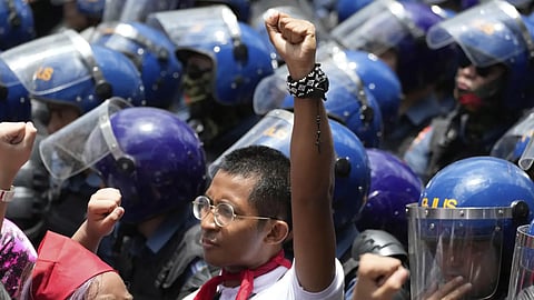 An activist raises his clenched fist during a May Day rally in Manila, Philippines, Thursday, May 1, 2025.