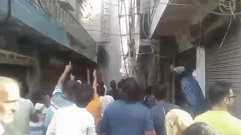 A woman reportedly threw her child from a window to save it as the fire broke out 