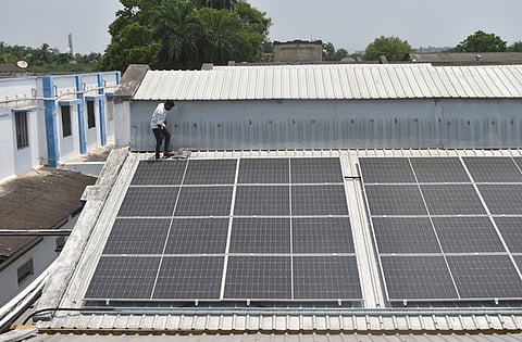 A worker installing rooftop solar panels on the roof (Representative Image)