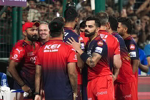 Royal Challengers Bengaluru's Virat Kohli and others celebrate in the dugout after RCB won the Indian Premier League (IPL) 2025 T20 cricket match against Delhi Capitals, at the Arun Jaitley Stadium, in New Delhi, Sunday, April 27, 2025.