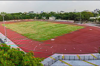 Madras High Court has temporarily stayed the award of tender and work order issuance by the police department to a private firm for laying synthetic tracks.