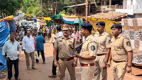 Police personnel at the site after a stampede broke out at a village during a temple festival, in North Goa district.