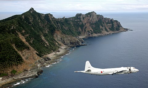 Japan Maritime Self-Defense Force P-3C Orion surveillance plane flies over the disputed islands in China, in the East China Sea.