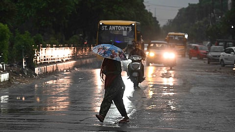 Pedestrians walking in rain on Friday, 2 May, 2025.