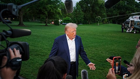 President Donald Trump speaks with reporters after disembarking Marine One upon arrival on the South Lawn of the White House in Washington, Sunday, May 4, 2025. 